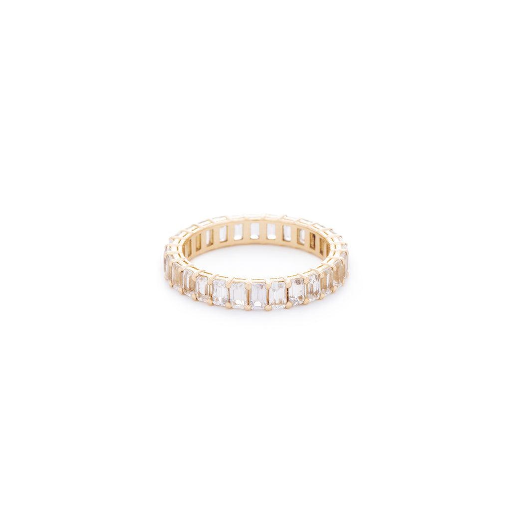 White emerald cut sapphire ring. Handcrafted in Australia from with custom cut petite size natural sapphires with 18K gold band. All stones individually assessed by certified gemologist.