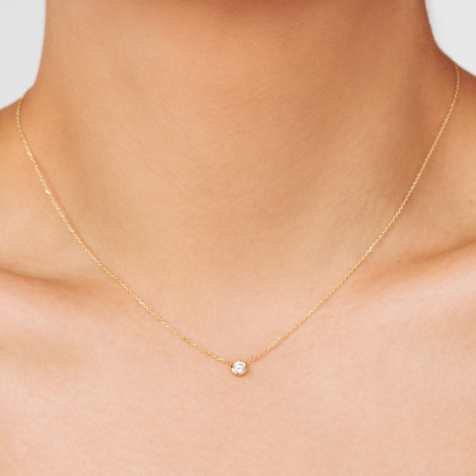 Colourless brilliant cut F/Si grade diamond necklace, celebrating the month of February on an 18K Gold chain.  Handcrafted in Australia as a perfect jewellery gift for an upcoming anniversary or birthday. A perfect statement piece on its own as a choker or layered in a stack. 